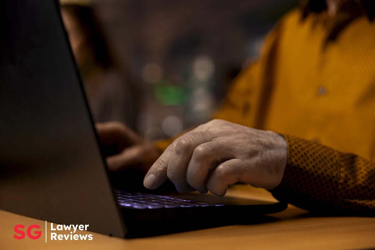 Scammer Working on Laptop in Singapore